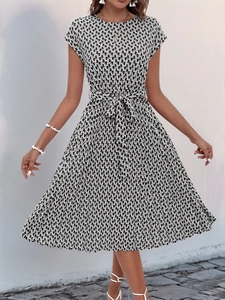 Detail of summer geometric print dress with waist tie and abstract monochrome pattern