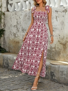Detail view of floral print midi dress featuring smocked bodice and side slit design