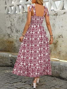 Detailed back view of a bohemian floral maxi dress with smocked bodice and tie straps