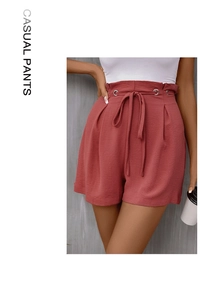 Detail of high waisted red casual shorts with drawstring waist and metal eyelets