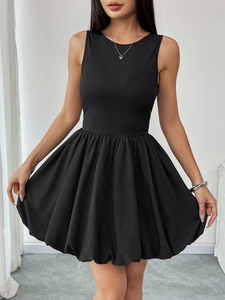 Detail of a black sleeveless balloon dress featuring ribbed knit bodice and puffy skirt hem