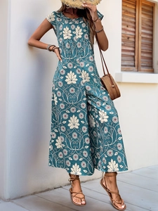Detail of bohemian wide-leg jumpsuit with floral print and high waist cut in deep teal
