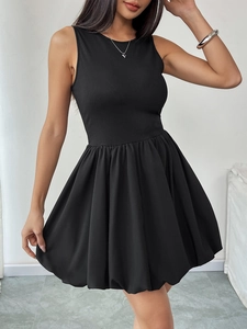 Detail of black sleeveless mini dress featuring ribbed bodice and voluminous bubble hem