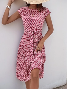 Detail of red and white geometric print dress with short sleeves and waist tie belt