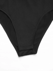 Close-up of black lace bodysuit featuring reinforced stitching and bottom snap closures