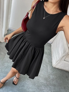Macro view of black backless mini dress with ribbed knit bodice and flared bubble hem skirt