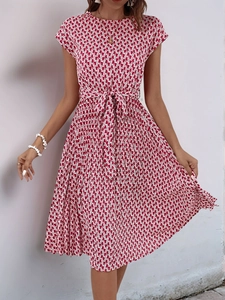 Detail of red and white geometric print summer dress with waist tie and pleated skirt