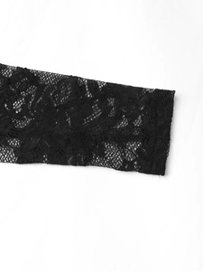 Detailed close-up of intricate black lace floral patterns and delicate mesh fabric texture