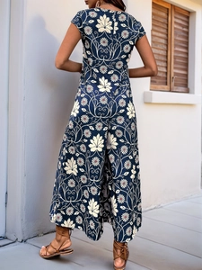 Detail view of vintage dark blue wide-leg jumpsuit with floral and maple leaf print