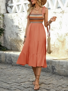 Detail of bohemian summer dress showing smocked bodice and geometric ethnic embroidery