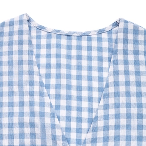 Detail of V-neckline on blue and white gingham shirt with fine stitching quality