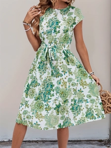 Detailed view of the green floral print on a short-sleeved tie-waist pleated summer dress