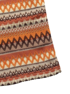 Close-up of bohemian chevron crochet knit fabric in orange and brown tones