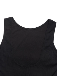 Detail of ribbed knit texture and stitching on a black backless mini dress neckline