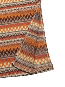 Close-up of bohemian wave pattern knit fabric showing refined side split and stitching