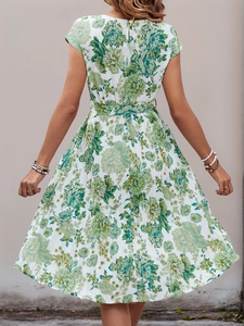 Back view of summer pleated A-line midi dress with green floral print and waist tie