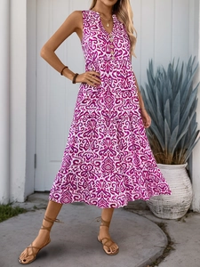 Detail of V-neckline with decorative buttons on a purple floral bohemian summer dress