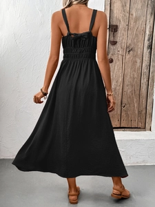 Detailed back view of black textured sleeveless dress with backless bow tie design