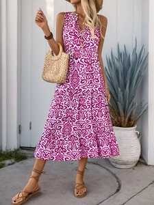 Detail of V-neck floral vacation dress with wood buttons and tiered bohemian skirt