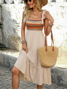 Detail of bohemian summer dress with colorful geometric woven chest panel and thin straps