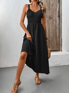 Detail of black textured summer dress featuring high-waist pleated design and maxi length