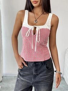 Detailed close-up of red and white plaid camisole with white trim and drawstring tie