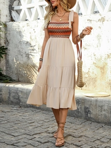 Detail showing Bohemian geometric embroidery on a light apricot strap summer dress