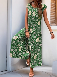 Detail of bohemian dark green wide-leg jumpsuit with white daisy floral prints