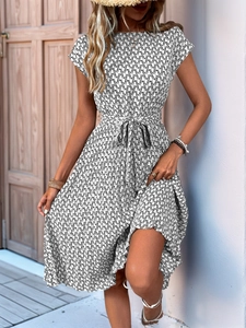 Detail of bohemian geometric print dress with short sleeves and matching waist tie belt