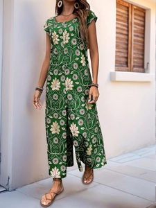 Detail of green floral wide-leg jumpsuit with daisy print and casual summer styling