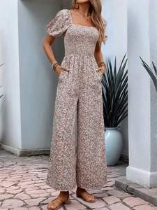 Detail of square neck floral jumpsuit with smocked bodice and puff short sleeves