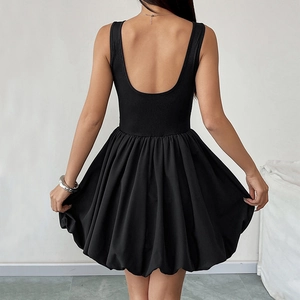 Back view of a sleek black backless mini dress with a voluminous puff hem and U-shaped cutout