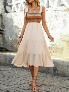 Bohemian midi dress featuring a knit geometric bodice and tiered skirt in beige tones
