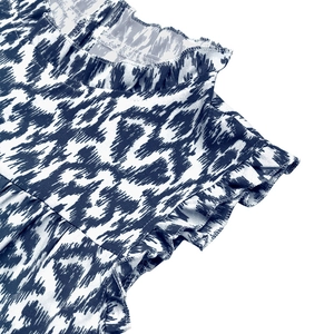 Detail of ruffle neckline and sleeveless flutter sleeves on blue ikat print summer dress