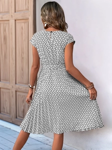 Back view of a summer A-line dress featuring geometric prints and a waist-tie detail