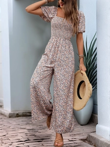 Detail of smocked waist floral jumpsuit with square neck and puff sleeves in light blue