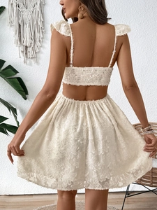 Detail of white bohemian backless dress with ruffled sleeves and textured jacquard fabric