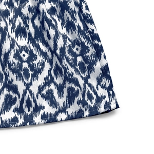 Detailed view of the blue and white ikat pattern fabric with clean hemline stitching