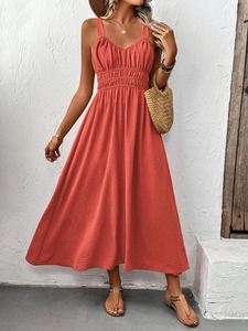 Detail of coral textured maxi dress featuring ruched bodice and summer resort style