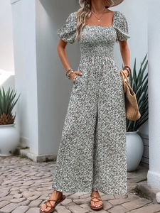 Detail of smocked bodice and square neckline on a floral puff sleeve wide-leg jumpsuit