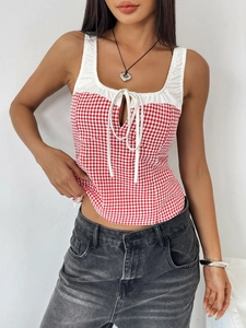 Detail of red and white plaid sleeveless top with front bow tie and cutout design