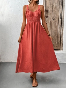Detailed texture of coral orange sleeveless maxi dress with pleated bodice and elastic waist