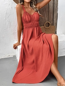 Detail of smocked high waist and v-neck on a brick red textured sleeveless maxi dress