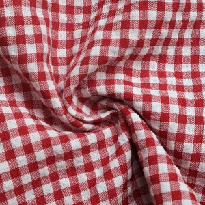 Detail of red and white gingham fabric with fine texture and natural soft folds