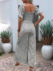 Detail of floral wide-leg jumpsuit with square neck and back smocking detail