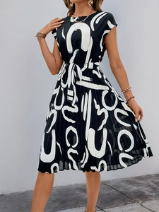 Detailed close-up of the black and white abstract print and pleated skirt texture