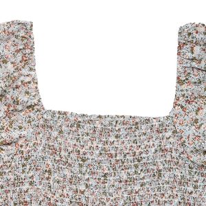 Detail of square neck floral jumpsuit with smocked bodice and puff sleeves design