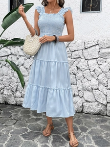Detail of blue and white striped tiered dress with smocked bodice and ruffled straps