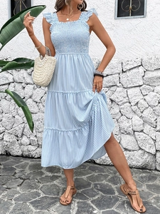 Detail of smocked bodice and ruffled straps on light blue striped tiered maxi dress