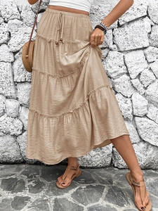 Detail of khaki tiered maxi skirt featuring elastic drawstring waist and pleated layers